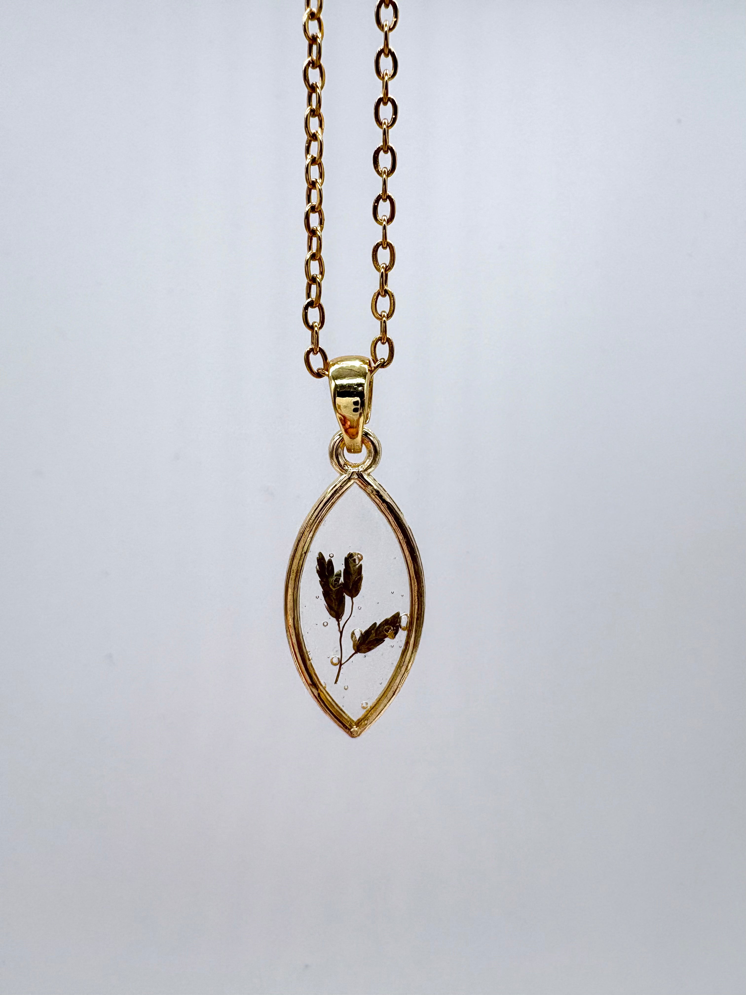 Goldkette mit Barreliers Liebesgras in Augenform, Detail, filigranes Design mit Blumenanhänger 
