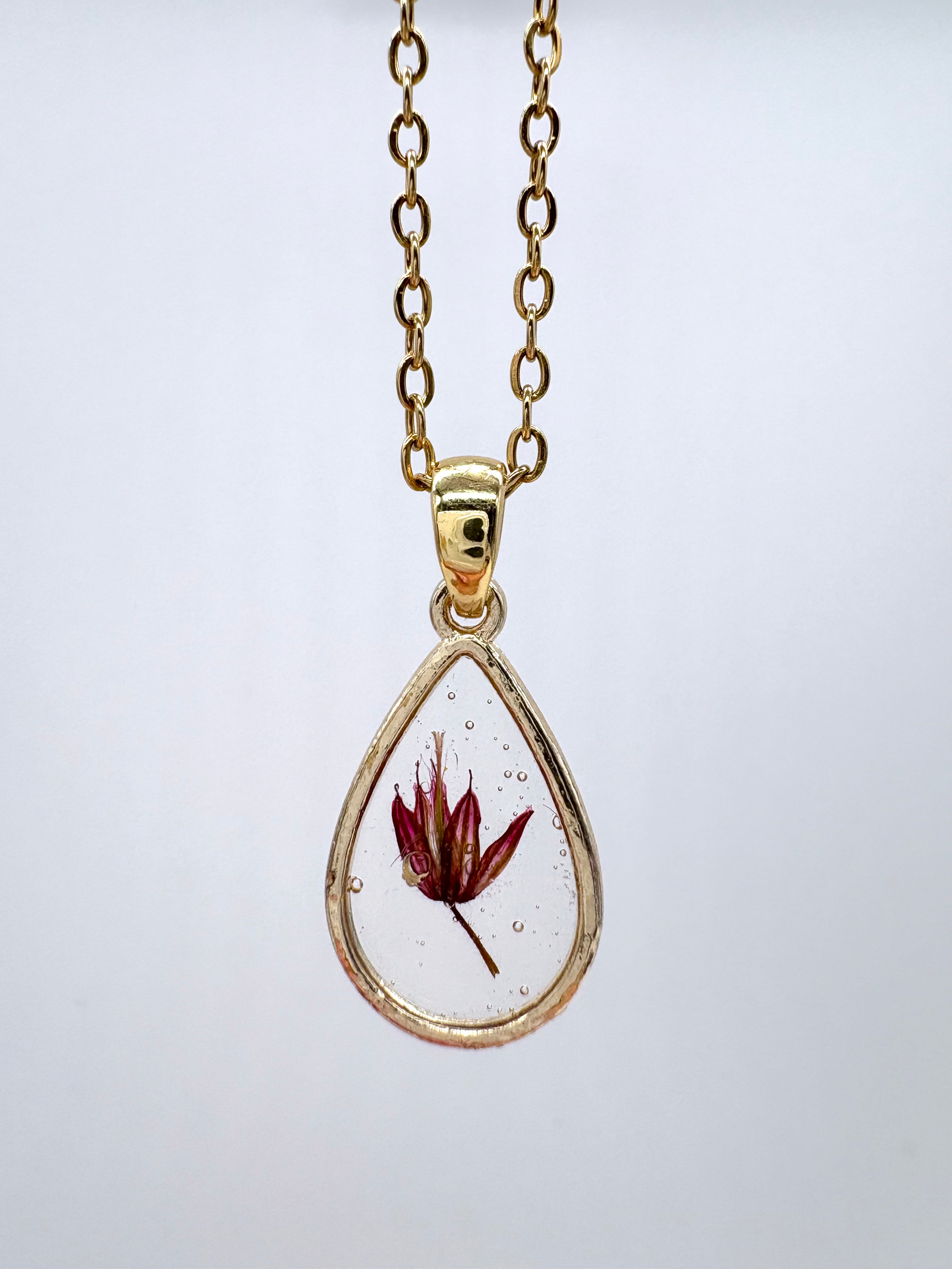 Goldkette mit Purpurstorchschnabel in Augenform, Detail, filigranes Design mit Blumenanhänger 
