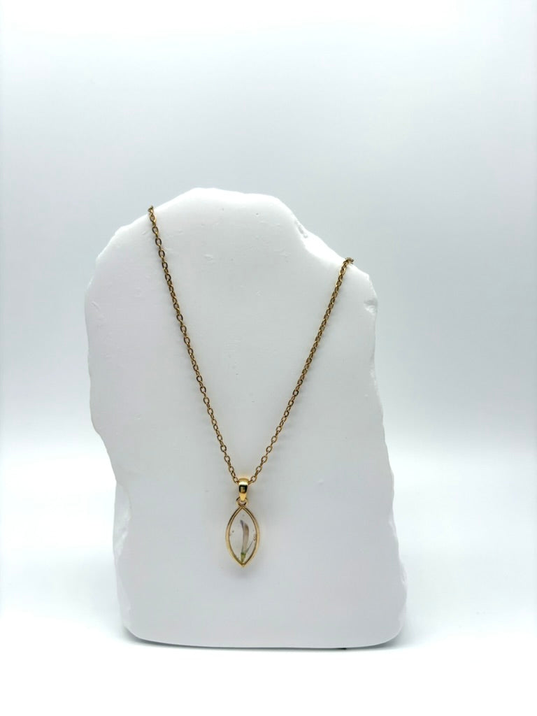 Goldkette mit Rotklee in Augenform, getragen, filigranes Design mit Blumenanhänger 
